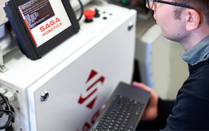 A worker using a SAGA-branded HMI screen